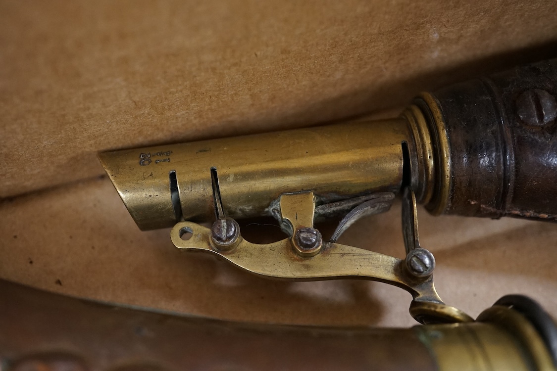 Nine powder flasks and shot flasks, all 19th century, comprising of two horn flasks, one flattened with brass mounts, three shot bags with sprung brass chargers, three copper gun flasks and another of zinc